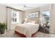 Bright bedroom featuring a ceiling fan, carpeted floor, and a comfortable bed with colorful pillows at 5228 Bee Balm St, Lake Hamilton, FL 33851