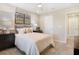 This comfortable bedroom features a queen bed, stylish bedside decor, and neutral walls with wall art at 5228 Bee Balm St, Lake Hamilton, FL 33851