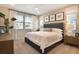 Bright bedroom featuring a ceiling fan, carpeted floor, and a comfortable-looking bed with white bedding at 5228 Bee Balm St, Lake Hamilton, FL 33851