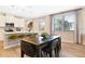 Elegant dining area with a modern table setting and large windows offering natural light, connected to the kitchen at 5228 Bee Balm St, Lake Hamilton, FL 33851