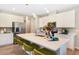 Modern kitchen with stainless steel appliances, a spacious island, and stylish seating for casual dining at 5228 Bee Balm St, Lake Hamilton, FL 33851
