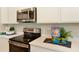 Bright kitchen featuring stainless steel appliances, stylish countertops, and contemporary cabinetry for ample storage at 5228 Bee Balm St, Lake Hamilton, FL 33851