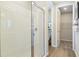 Shower with white tiled walls and a glass door next to the toilet and entrance to the walk-in-closet at 5228 Bee Balm St, Lake Hamilton, FL 33851