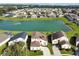 Aerial view of homes backing to a picturesque lake within a well-maintained residential community at 553 Bailey Cir, Davenport, FL 33897