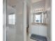The bathroom features a single sink vanity, glass shower door, and neutral color palette at 553 Bailey Cir, Davenport, FL 33897