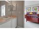 This bathroom features a single sink vanity, a door to the bedroom, and an open doorway at 553 Bailey Cir, Davenport, FL 33897