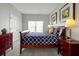 This bedroom includes a queen sized bed, with a modern decor and lots of natural light at 553 Bailey Cir, Davenport, FL 33897