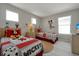 bedroom featuring two beds with character bedding, natural light, and playful decor at 553 Bailey Cir, Davenport, FL 33897
