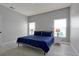 This bedroom boasts two windows, two bedside tables with lamps, and light gray walls at 553 Bailey Cir, Davenport, FL 33897