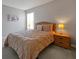 Inviting bedroom with a queen-sized bed, wooden nightstands, soft lighting, and minimalist decor at 553 Bailey Cir, Davenport, FL 33897