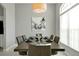 Formal dining room featuring modern decor, a stylish light fixture, and ample natural light at 553 Bailey Cir, Davenport, FL 33897