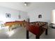 This game room includes a pool table and a foosball table for indoor entertainment at 553 Bailey Cir, Davenport, FL 33897