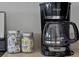 Kitchen countertop featuring a coffee maker and condiments in clear jars at 553 Bailey Cir, Davenport, FL 33897