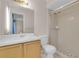 Bathroom featuring a large mirror above the sink and a glass door shower at 572 Floral Dr, Kissimmee, FL 34743