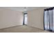 This carpeted bedroom features white walls, two windows with curtains, and a ceiling fan at 572 Floral Dr, Kissimmee, FL 34743