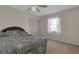 A bedroom with carpet, ceiling fan, a window with sheer curtains, and closet with folding doors at 572 Floral Dr, Kissimmee, FL 34743