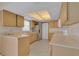 Bright kitchen featuring light wood cabinetry, tile flooring, and stainless steel refrigerator at 572 Floral Dr, Kissimmee, FL 34743