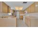 Well-lit kitchen with light wood cabinets, neutral countertops, and modern appliances at 572 Floral Dr, Kissimmee, FL 34743