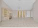 Large living room featuring tile flooring, neutral-toned walls, and built-in shelving unit at 572 Floral Dr, Kissimmee, FL 34743