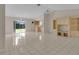 Spacious living room with tile floors, built-in shelving, ceiling fan, and sliding glass door to the backyard at 572 Floral Dr, Kissimmee, FL 34743