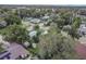 Aerial shot of a residential neighborhood with lush trees and well-maintained properties at 673 E Church Ave, Longwood, FL 32750