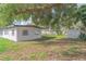 Lush backyard featuring mature trees and a convenient storage shed at 673 E Church Ave, Longwood, FL 32750