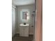 Modern bathroom featuring a sleek vanity with illuminated mirror and contemporary fixtures at 673 E Church Ave, Longwood, FL 32750
