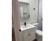 Modern bathroom with a white vanity cabinet, sink, sleek black faucet, and an LED mirror at 673 E Church Ave, Longwood, FL 32750