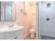 Bright bathroom featuring a modern vanity, decorative mirror, and updated shower with marble-style tile at 673 E Church Ave, Longwood, FL 32750