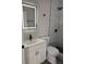 Modern bathroom featuring sleek fixtures, a vanity with an LED mirror, and a walk-in shower at 673 E Church Ave, Longwood, FL 32750