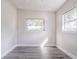 An empty bedroom featuring two bright windows and laminate flooring at 673 E Church Ave, Longwood, FL 32750