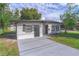 A charming single-story house featuring a recently paved driveway and fresh landscaping at 673 E Church Ave, Longwood, FL 32750