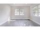 Living room with gray wood floors and natural light from the windows at 673 E Church Ave, Longwood, FL 32750