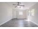 Living room features gray wood flooring, a ceiling fan, and a window at 673 E Church Ave, Longwood, FL 32750