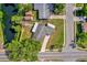 Aerial view of a single-Gathering home with mature trees, a lush lawn, a long driveway, and a view of the adjacent lake at 6824 Chaucer Ln, Orlando, FL 32809