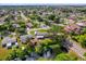 Aerial view of the home surrounded by mature trees, a pond, and a well-kept neighborhood at 6824 Chaucer Ln, Orlando, FL 32809