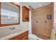 Bathroom features a shower over tub, wood cabinets, and a decorative tile shower at 6824 Chaucer Ln, Orlando, FL 32809