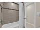Bathroom featuring a shower over tub with decorative tile backsplash and tiled niche at 6824 Chaucer Ln, Orlando, FL 32809