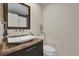 Stylish bathroom featuring an above-counter sink with designer faucet and a decorative mirror at 6824 Chaucer Ln, Orlando, FL 32809
