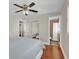 Bedroom featuring hardwood floors, a ceiling fan, and an en suite bathroom at 6824 Chaucer Ln, Orlando, FL 32809