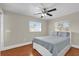Bedroom features hardwood floors, a ceiling fan, and natural light from two windows at 6824 Chaucer Ln, Orlando, FL 32809