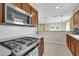 Well-equipped kitchen with a gas range, microwave, and a view into the living space at 6824 Chaucer Ln, Orlando, FL 32809