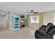 Comfortable living room featuring a built-in entertainment center and ample natural light at 6824 Chaucer Ln, Orlando, FL 32809