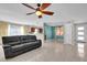 Spacious living room with tile flooring, a ceiling fan, and an open layout at 6824 Chaucer Ln, Orlando, FL 32809
