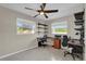 Home office space featuring natural light, two work stations, and built-in shelving at 6824 Chaucer Ln, Orlando, FL 32809