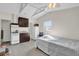 Studio including kitchenette with white appliances, neutral walls, and ample lighting at 6824 Chaucer Ln, Orlando, FL 32809