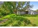 Spacious backyard with mature tree that offers shade, creating a relaxing outdoor space at 707 Stonewyk Way, Kissimmee, FL 34744