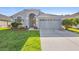Charming single-story home featuring a manicured lawn and an attached two-car garage at 707 Stonewyk Way, Kissimmee, FL 34744