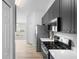 A modern kitchen featuring stainless steel appliances and sleek gray cabinetry at 707 Stonewyk Way, Kissimmee, FL 34744