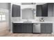This kitchen features shaker cabinets, stainless steel appliances, and quartz countertops at 707 Stonewyk Way, Kissimmee, FL 34744